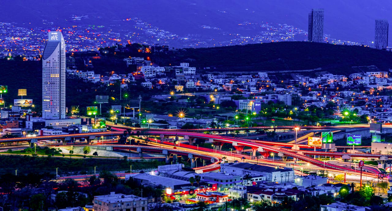 A stunning aerial view of Monterrey, Mexico at night showcasing vibrant city lights and modern architecture.