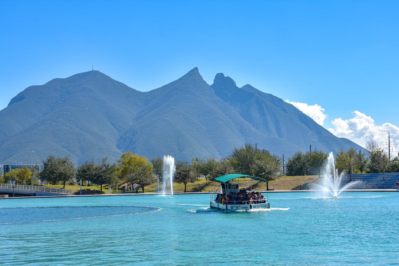home-img Scenic view of a boat on Paseo Santa Lucía with Monterrey's iconic mountains in the background.