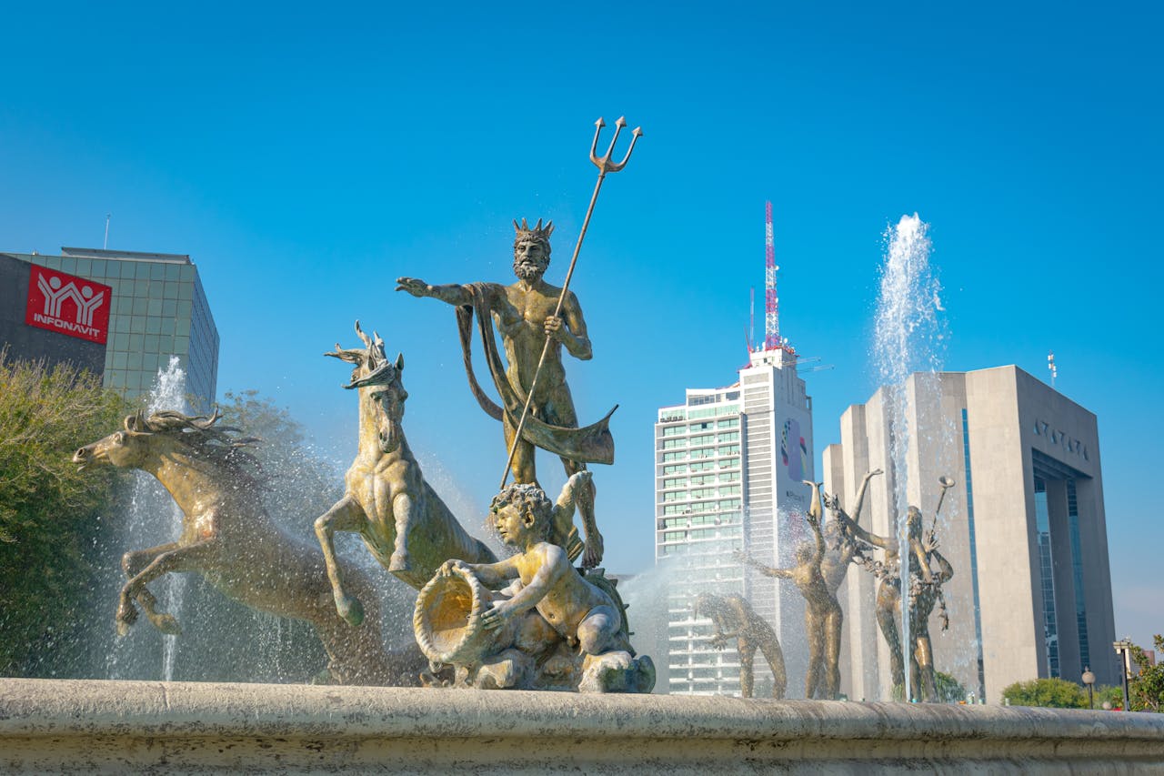 Stunning view of Neptune Fountain with modern Monterrey skyline in the background.