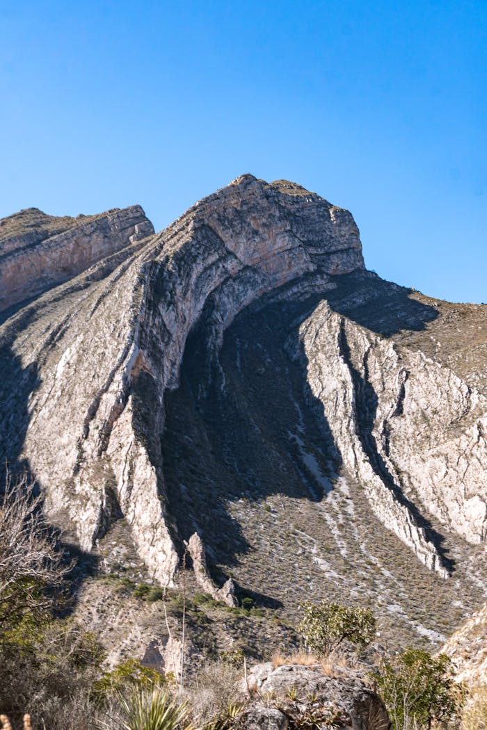 gallery-05 Dramatic sunlit rock formation in Monterrey, Mexico, showcasing natural beauty and geological features.